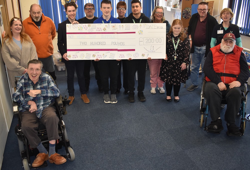 1WSC inclusive learning students present 200.00 to Headway in Bury