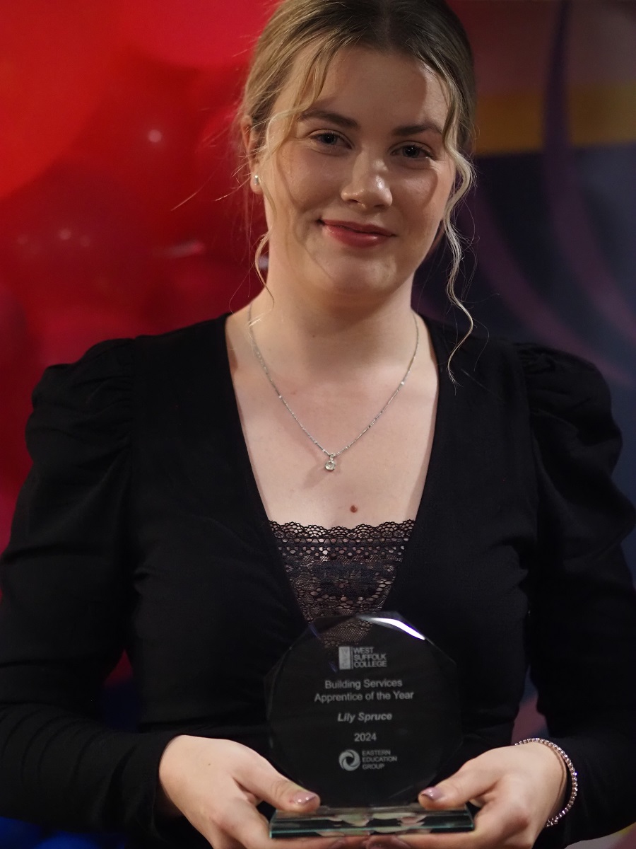 Lily Spruce with her Apprenticeship award trophy