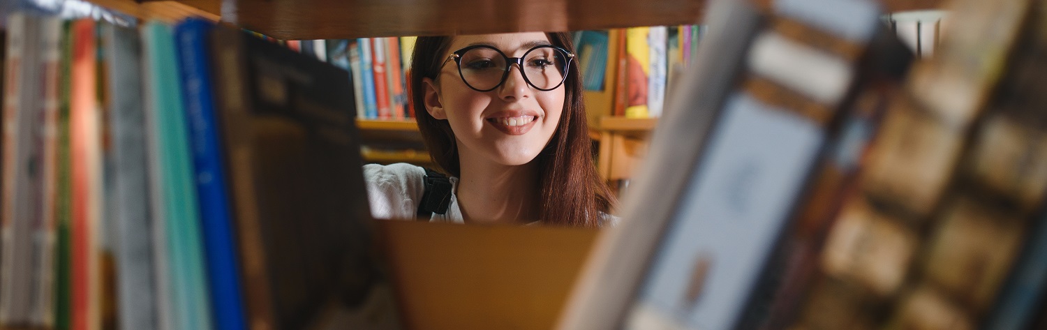 portrait of a student girl studying at library