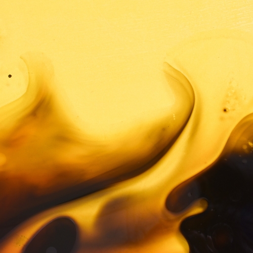 Photo of a yellow background with black smoke like waves