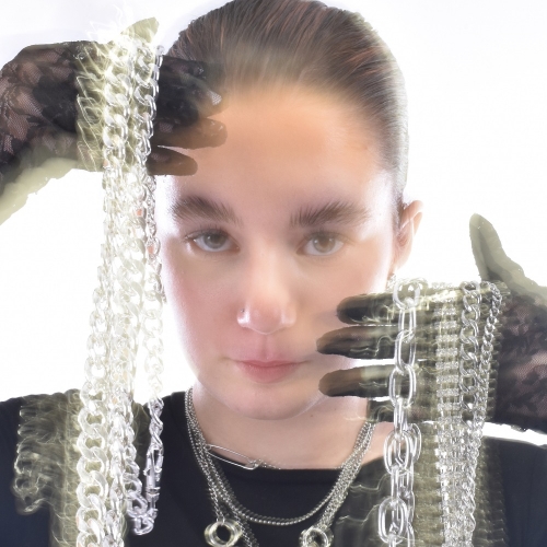 Photo of a person holding up chains with a blur effect over them
