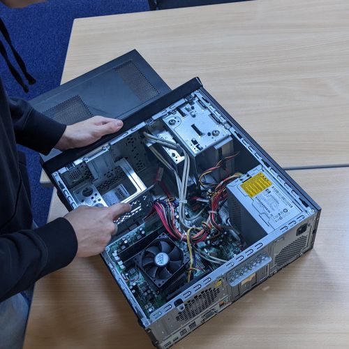 Photo of a person inspecting a computer